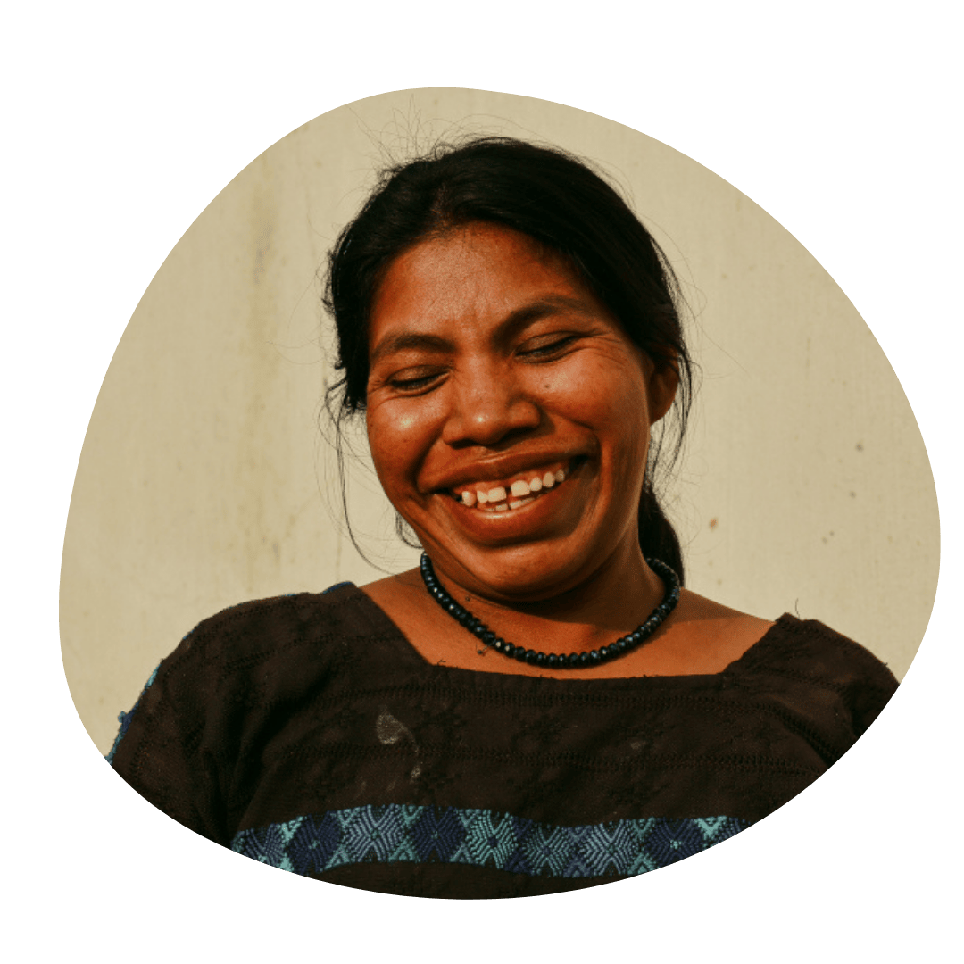 A smiling women farmer from Latin America - Groundswell international