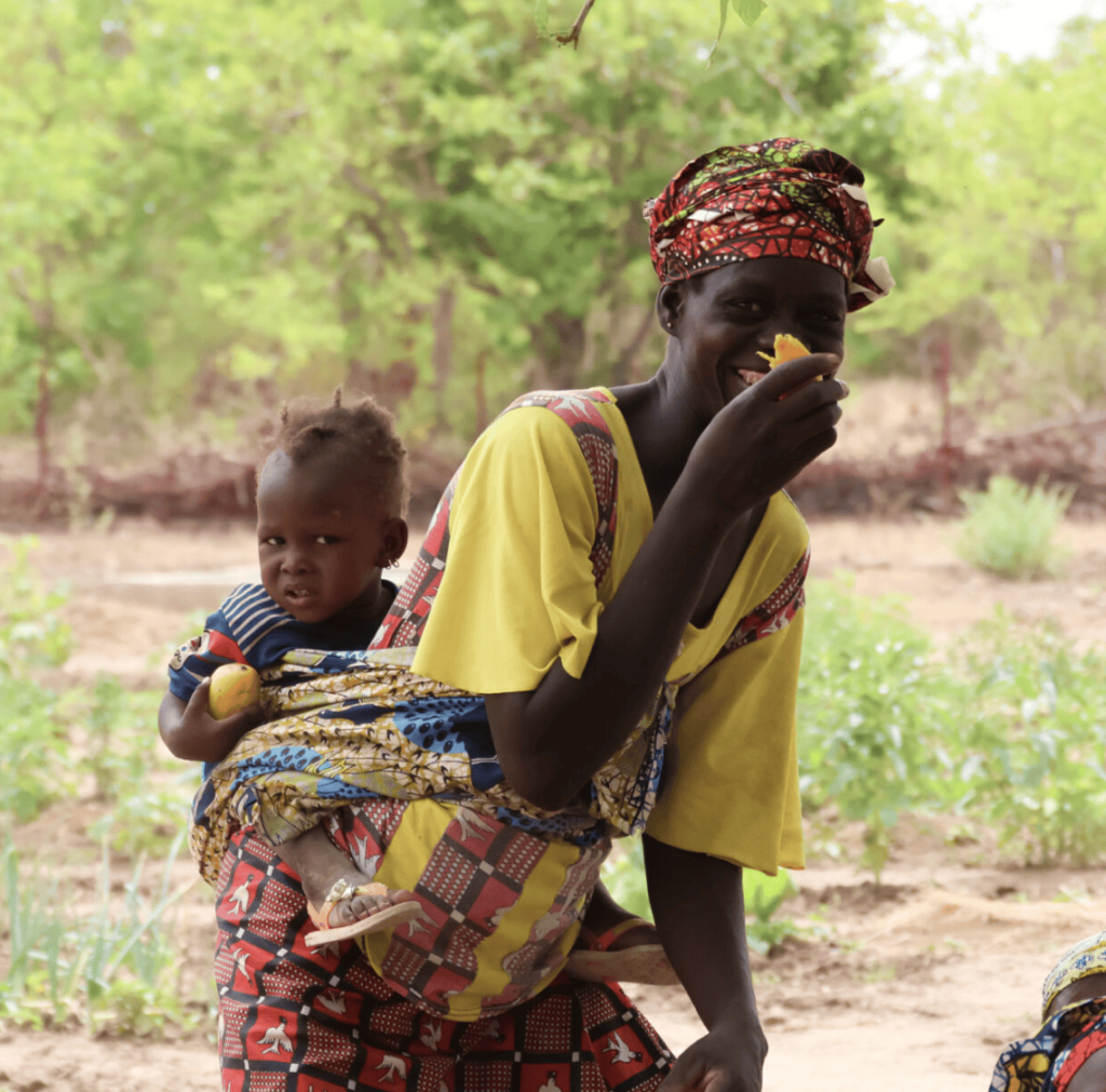 A displaced woman farmer with her baby in Mali