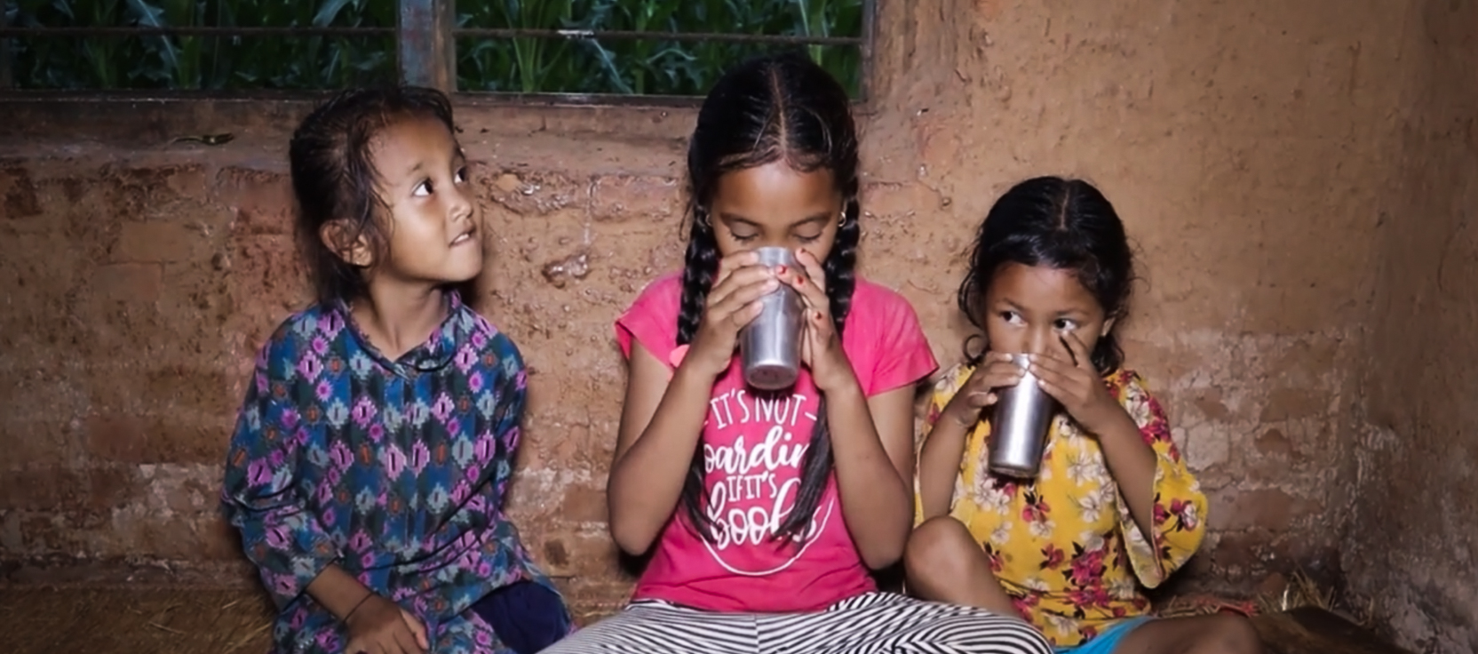 Samjhana's children drinking fresh milk