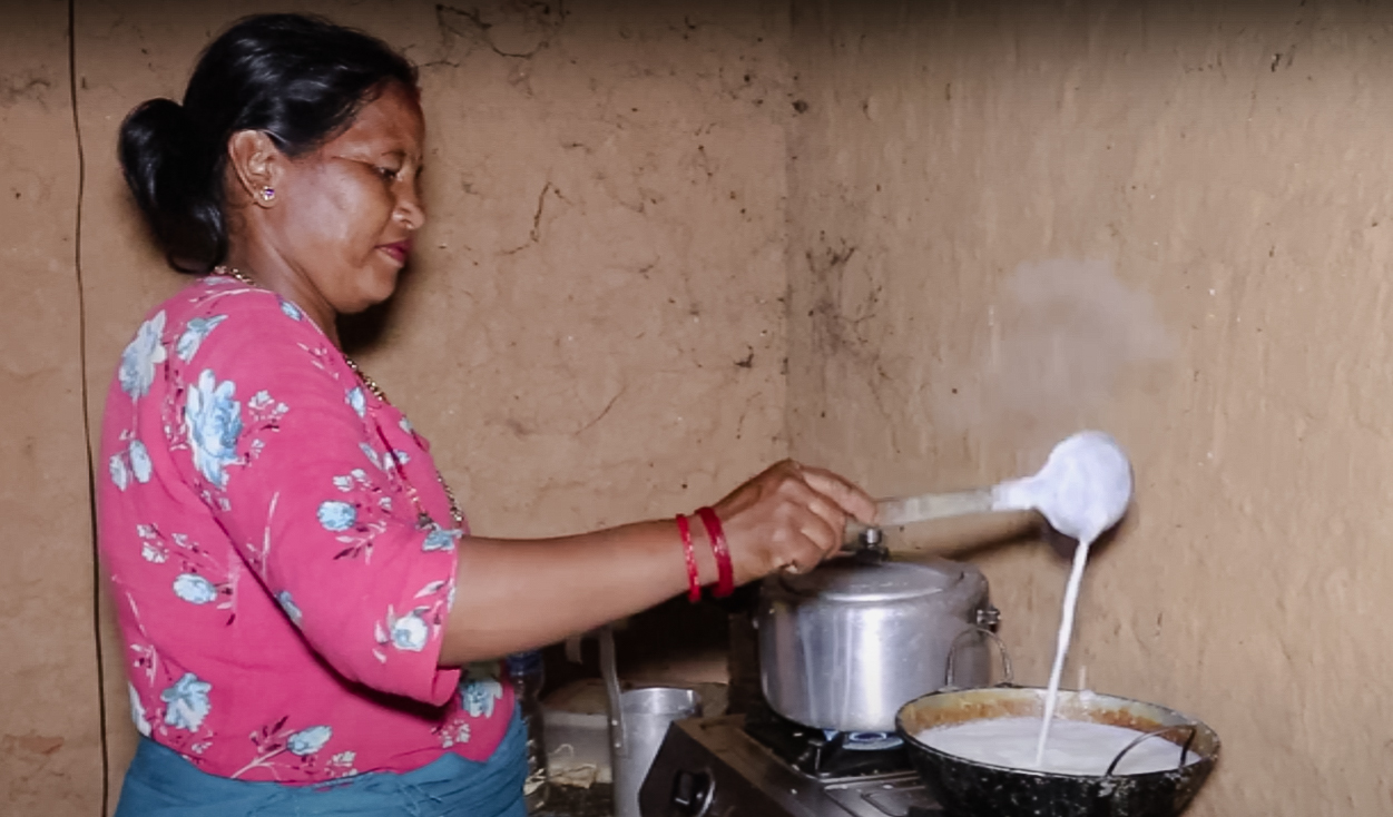 Samjhana preparing milk at home